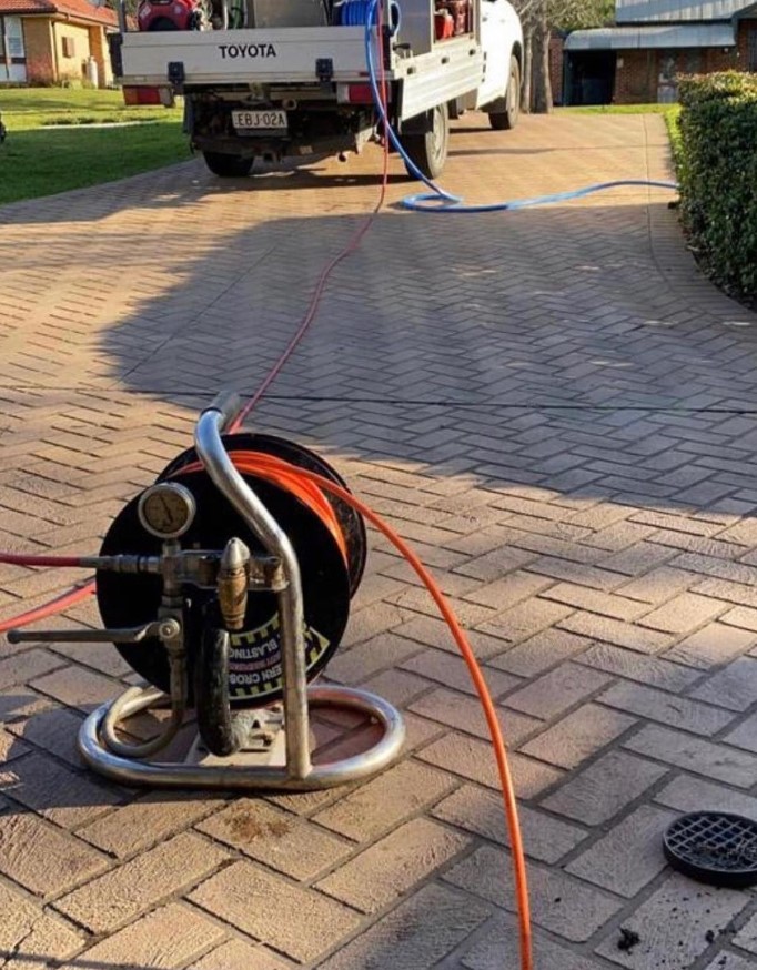 using a jet blaster to clean a blocked drain